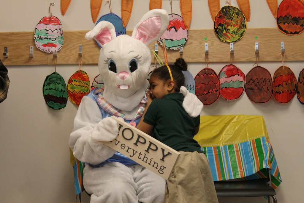 Holiday bunny is posing for a photo with students of Future Leaders Elementary